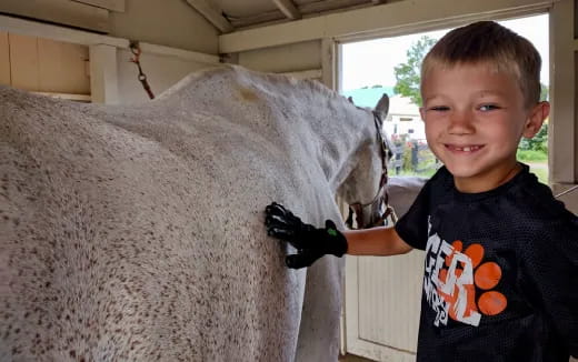 a boy holding a horse