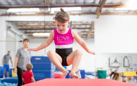 a boy jumping on a trampoline