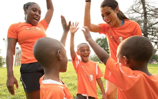 a group of people in orange shirts