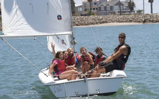 a group of people on a sailboat