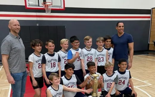 a group of people posing for a photo with a trophy