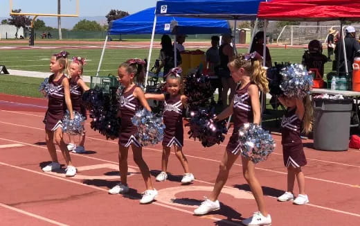 a group of cheerleaders on a track