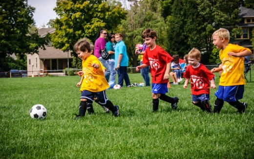 kids playing football on a field