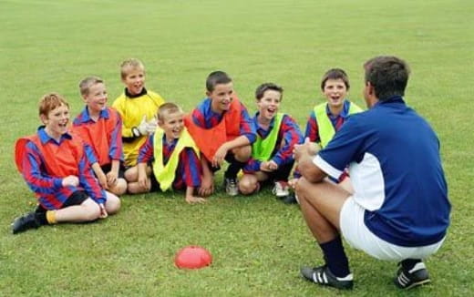 a group of football players sitting on the ground