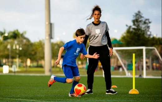 a person and a boy playing football