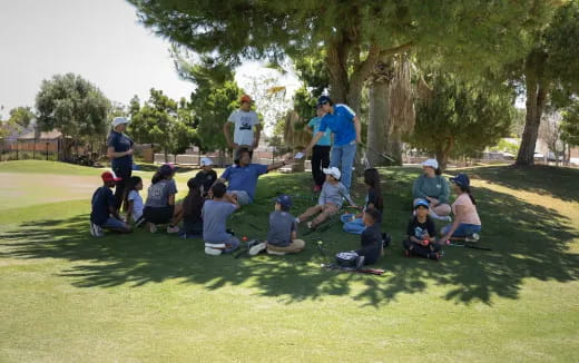 a group of people sitting on the grass