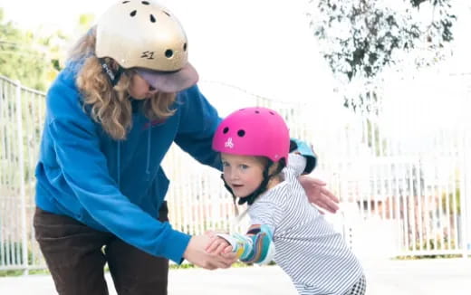 a person and a child wearing helmets