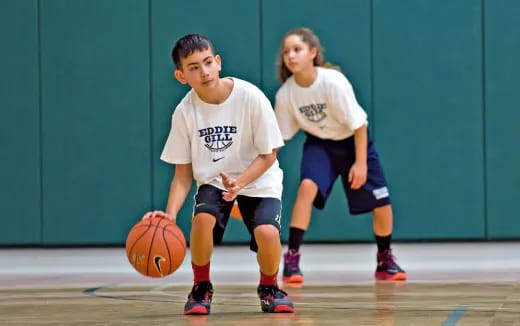 a couple of kids playing basketball