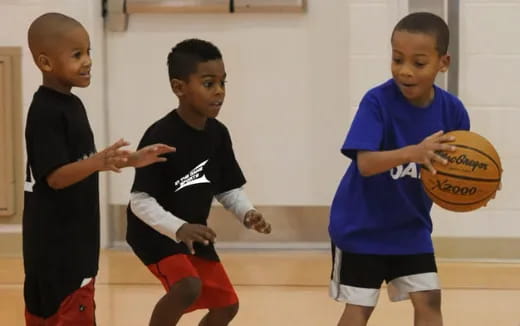 a group of boys playing basketball