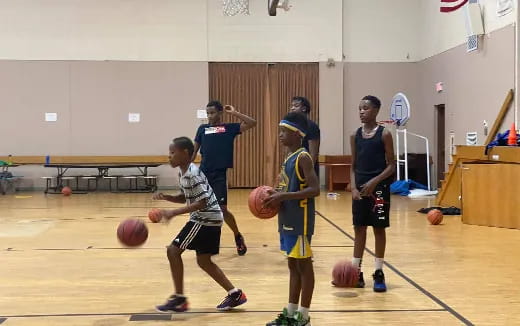 a group of kids playing basketball