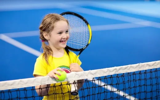 a girl holding a tennis racket