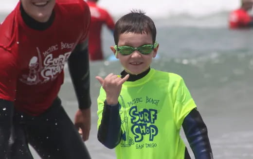 a boy wearing a green shirt and sunglasses