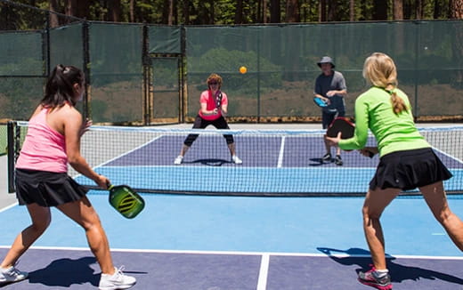 women playing tennis on a court