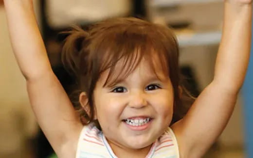 a girl with her hands on her head