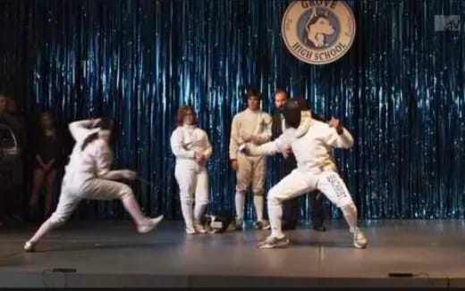a group of people in white karate uniforms on a stage