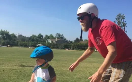 a man and a child wearing helmets