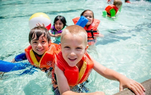 a group of children in a pool