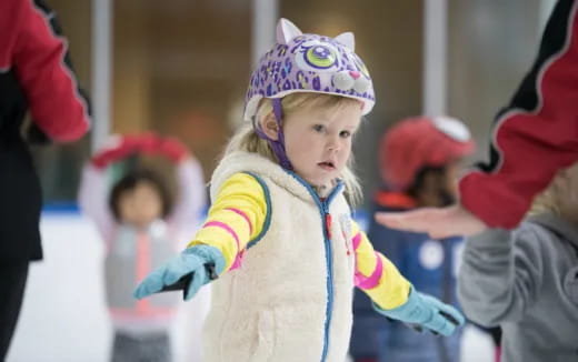 a little girl wearing a hat and gloves