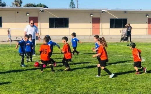 a group of kids playing football