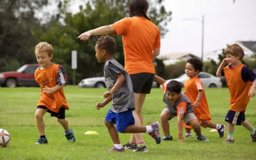 a group of kids playing football