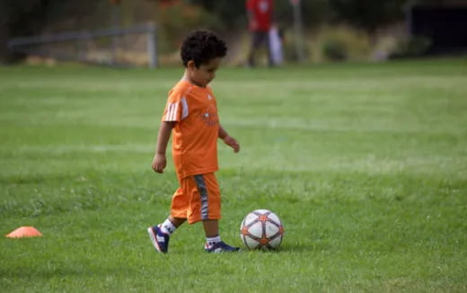 a young boy playing football