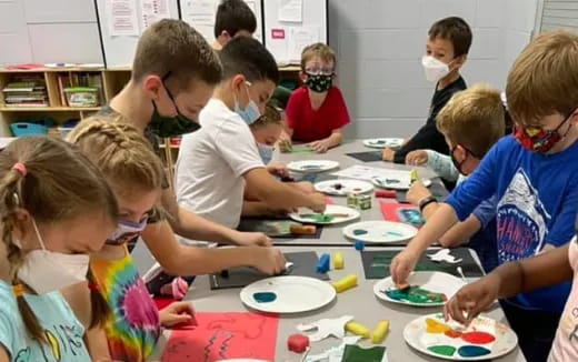 a group of children eating at a table