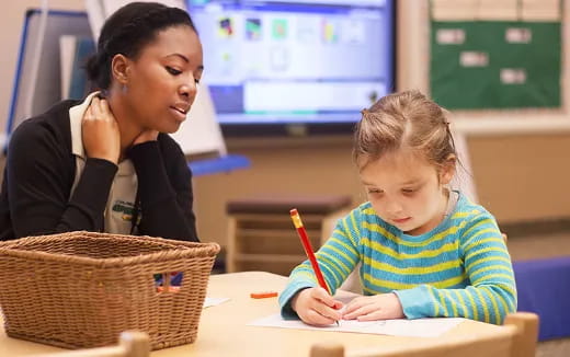 a person and a child sitting at a table