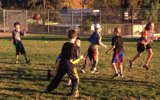 a group of kids playing with a frisbee