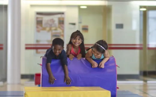 a group of children playing on a mat