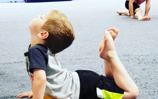 a boy sitting on the ground