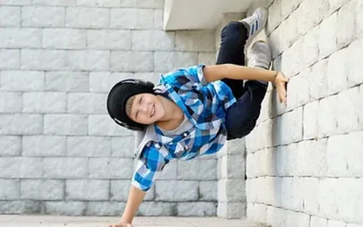 a boy leaning against a wall