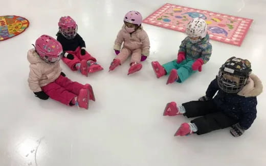 a group of children wearing snow gear