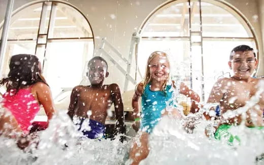 a group of children playing in water