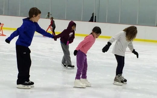 a group of children ice skating