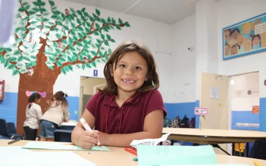 a girl sitting at a desk