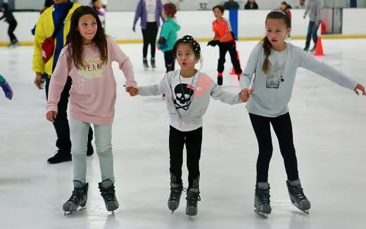 a group of women ice skating