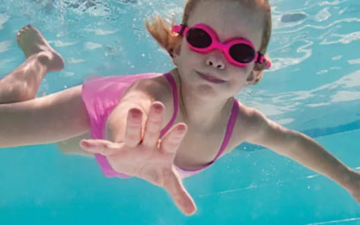 a baby in a pool wearing sunglasses