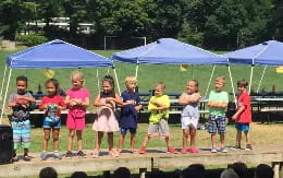 a group of children standing on a stage