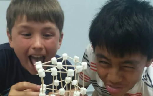 a couple of boys playing chess