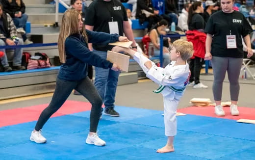 a person and a child in karate uniforms
