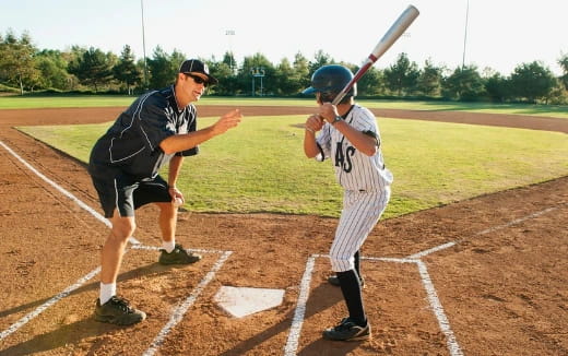 a baseball player prepares to swing a bat