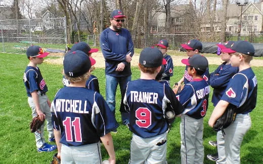 a group of kids in baseball uniforms