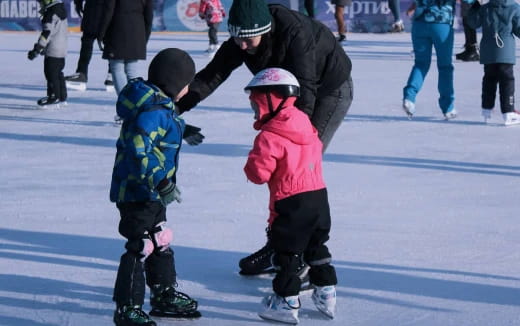 a person and two children ice skating