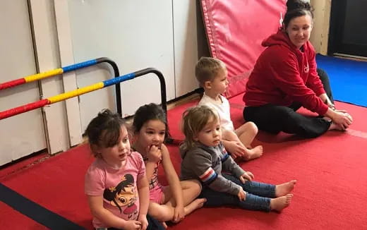 a person and several children sitting on the floor