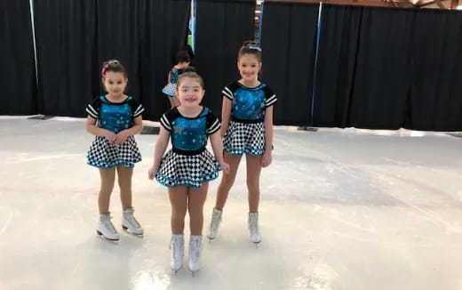 a group of girls wearing ice skates and ice skates
