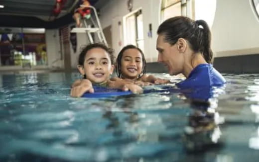 a person and two children in a pool