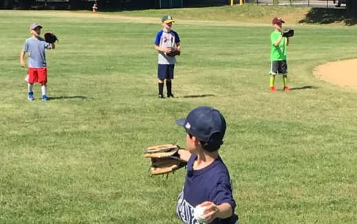 a group of kids playing baseball