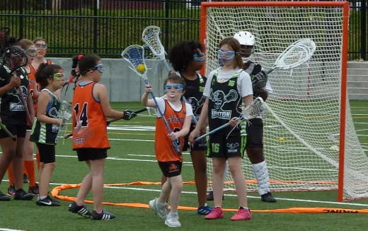 a group of girls playing lacrosse