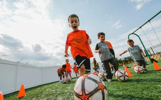 a group of kids playing football