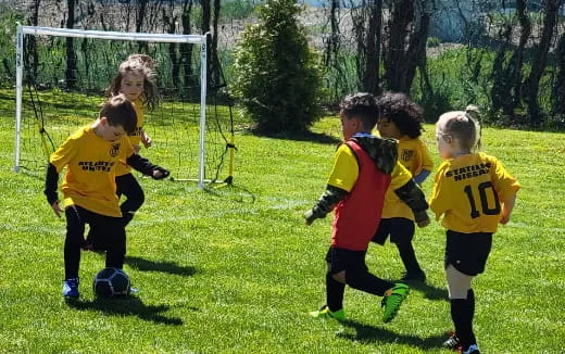 a group of kids playing football